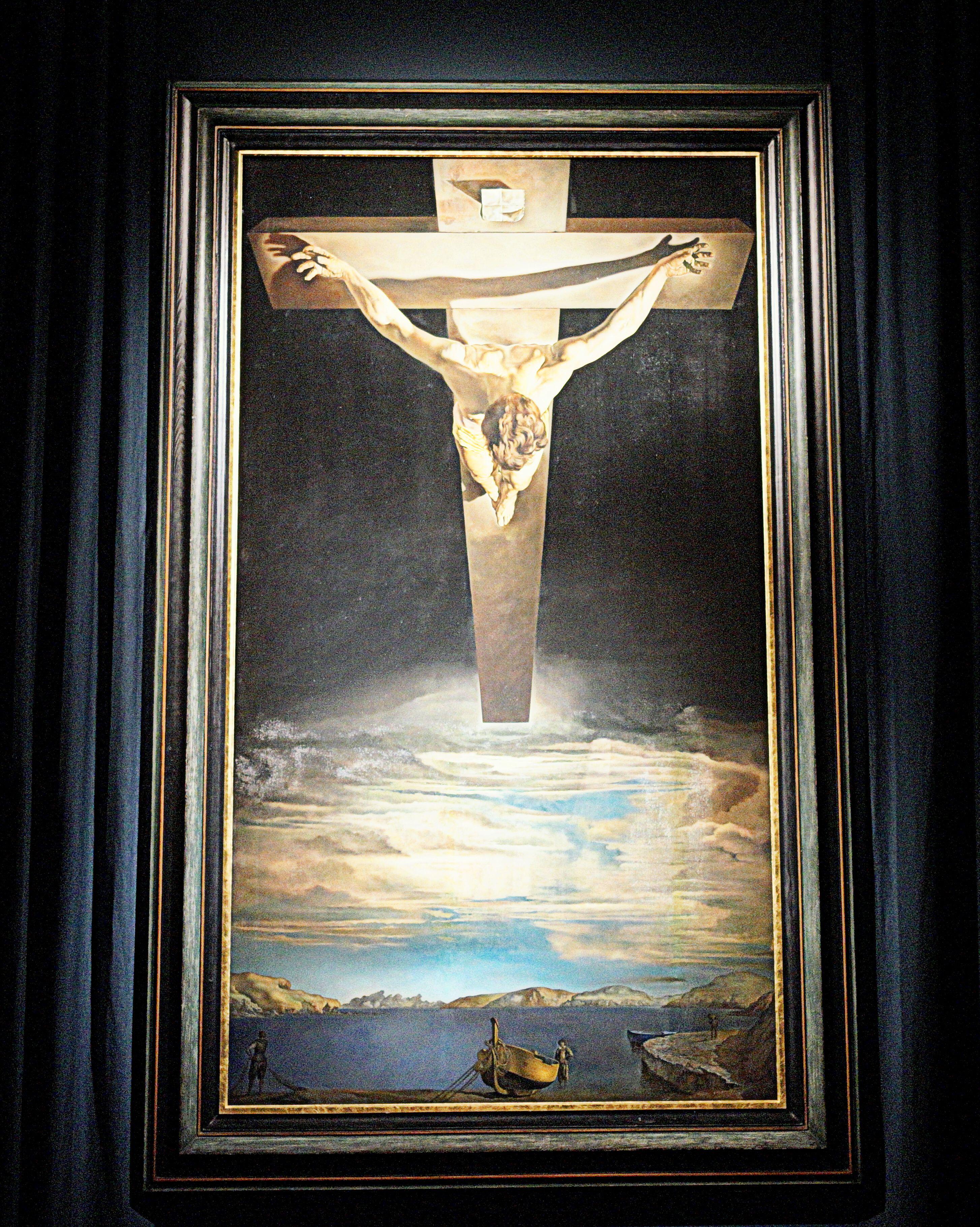 Dali's Christ of St John of the Cross, showing a man nailed to a cross looming over a coastal scene