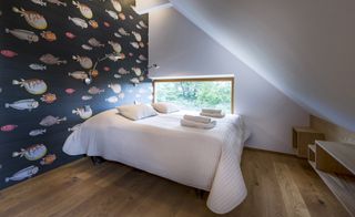 White bed and fish art wall