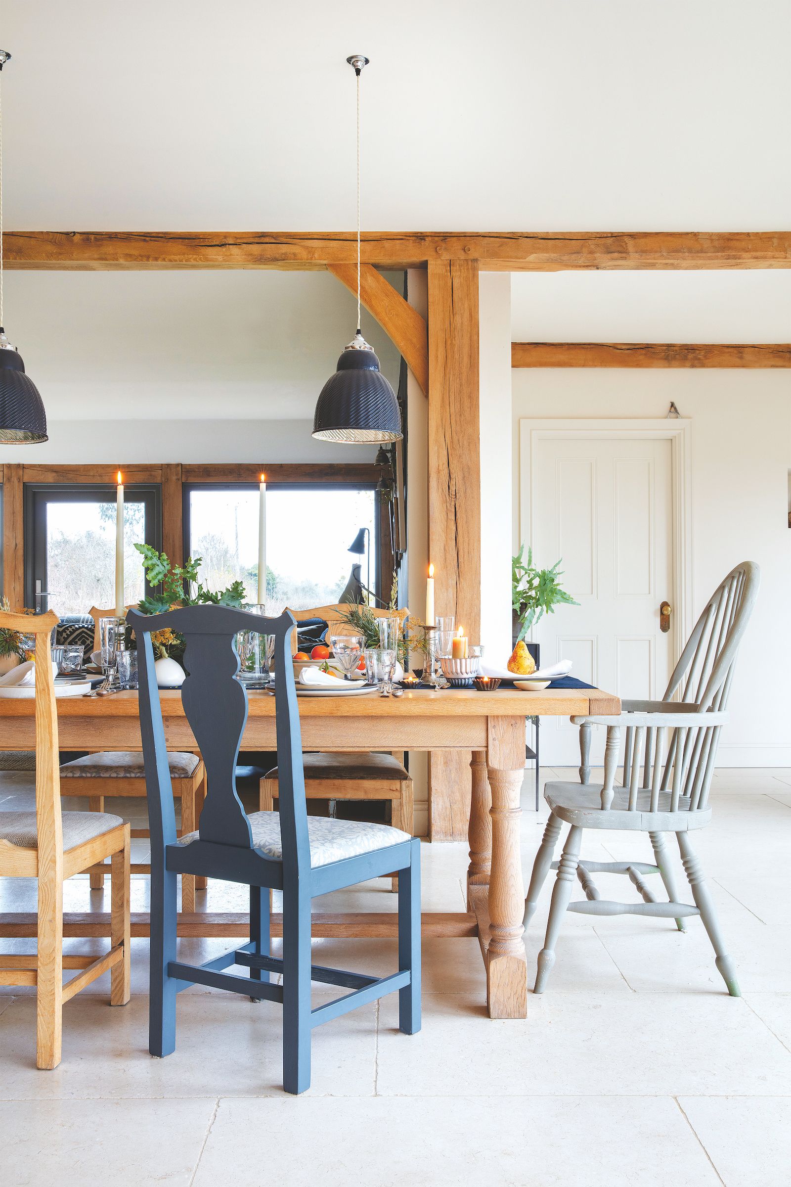 dining room with mismatched blue and white wood chairs