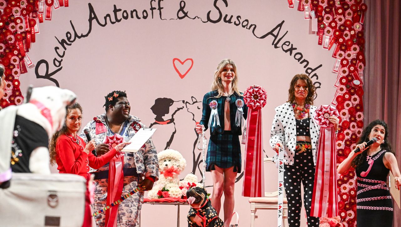 participants in a dog fashion show stand on top of a podium wearing rachel antonoff clothes and susan alexandra accessories