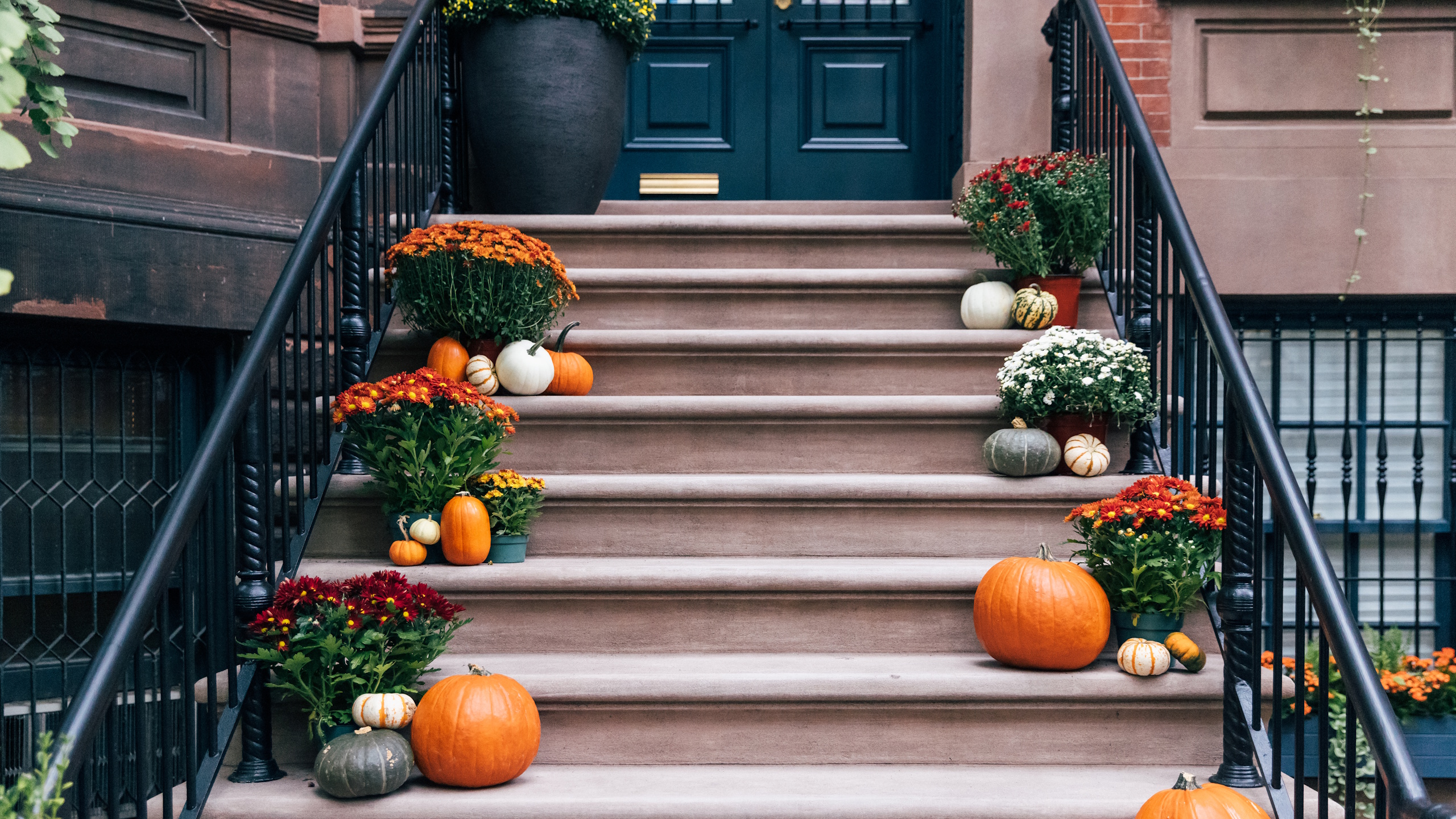 Pumpkins and fall flowers on apartment steps