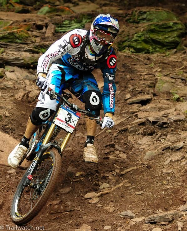Gee Atherton (Commencal) putting a foot down on a loose turn