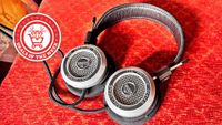 A picture of the Grado SR325x headphones on a red background, with the deals of the week logo overlaid