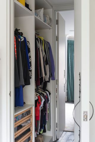 Organized small walk in wardrobe