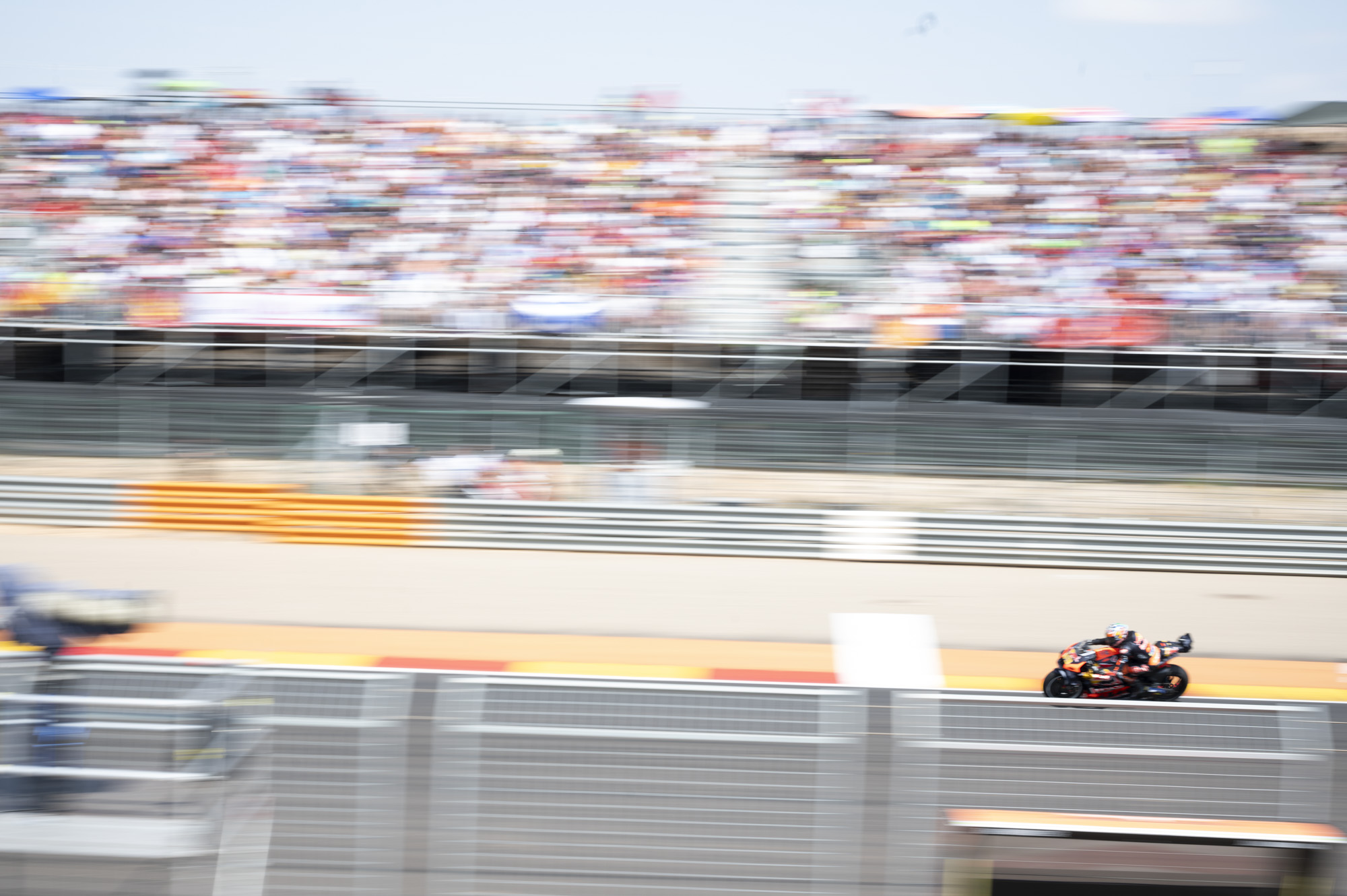 MotoGP racetrack and rider at full speed, blurry