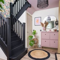 Hallway with black staircase and shoe storage