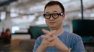 Still from a promotional video about Meta Project Aria Gen 2, showing an engineer wearing Aria smart glasses and testing the hand tracking capabilities