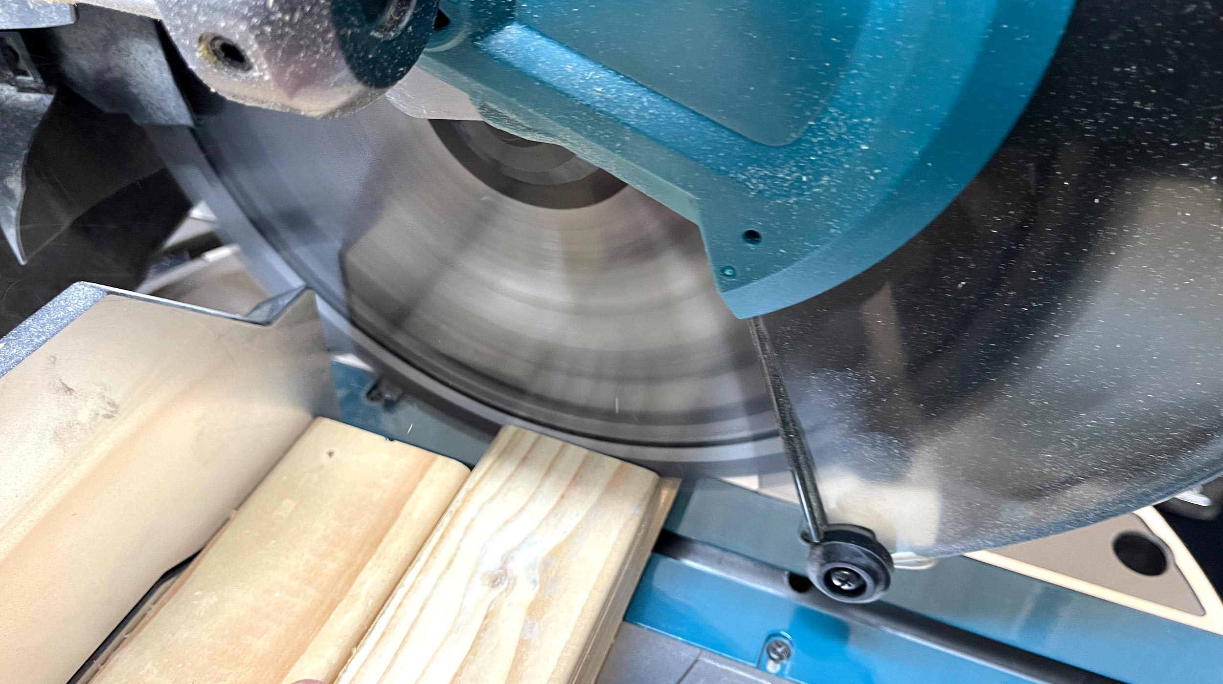Close up of Makita brushless slide compound mitre saw blade in motion