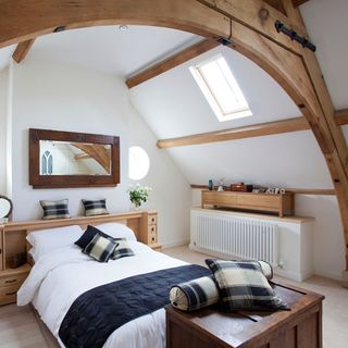 bedroom with wooden beams and white walls