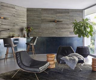Black leather chairs, plant, bar