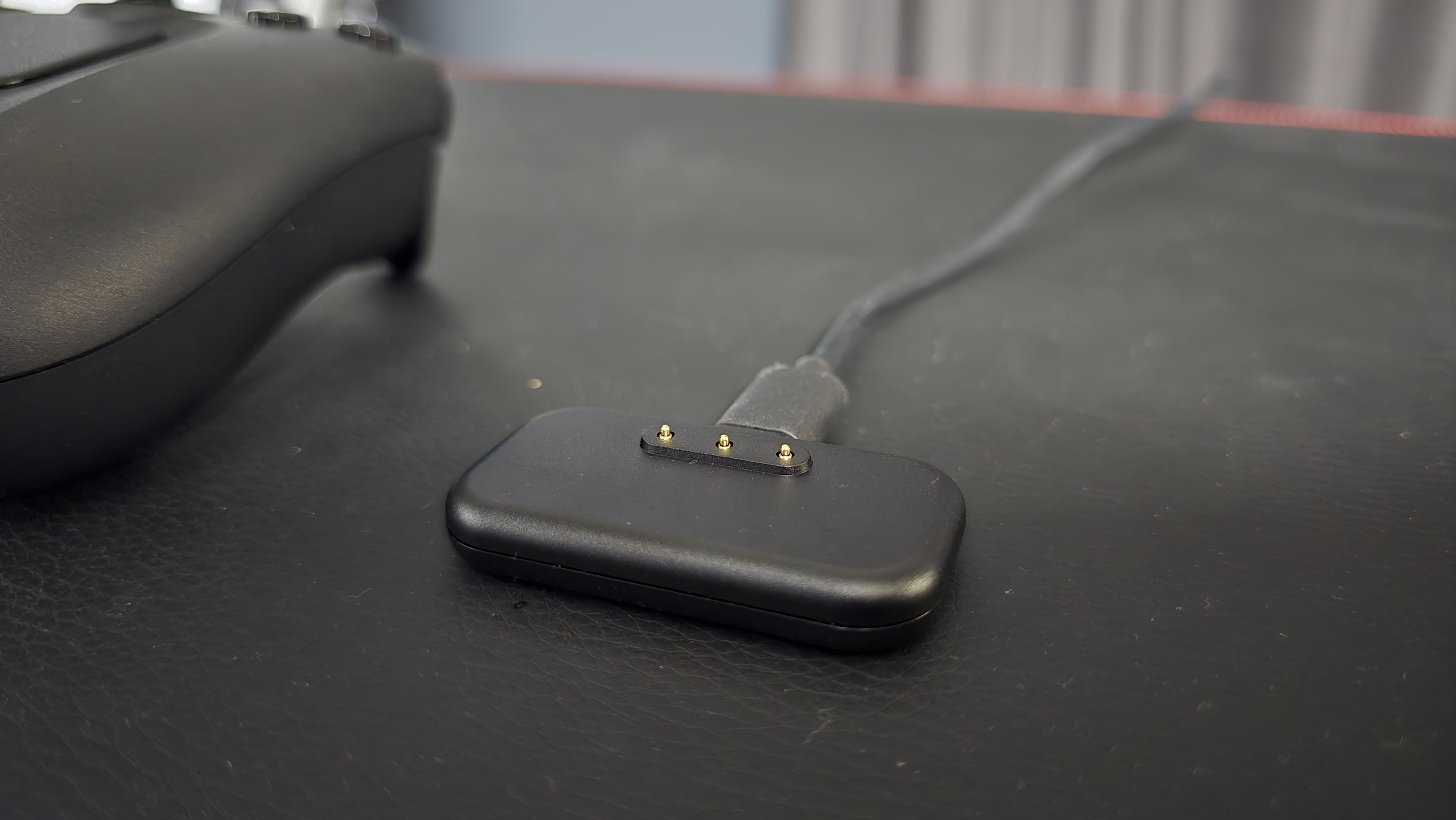 Valve Steam Controller (2026) charging puck on gamer desk