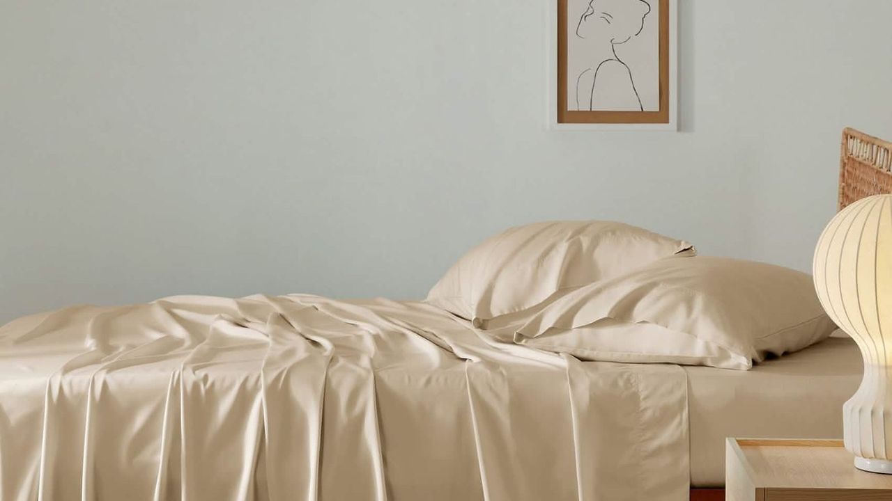 Bedsure Cooling Sheets in beige against a gray wall. 