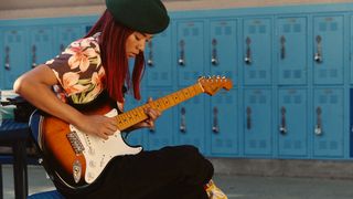 Woman playing electric guitar