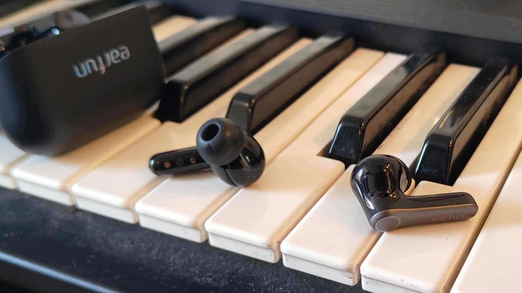 The Earfun Air Pro 4 Plus on top of a keyboard.