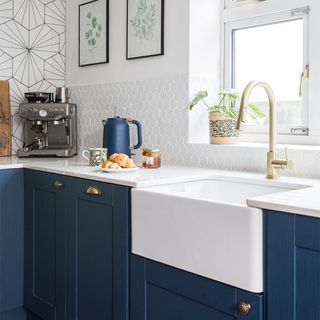 blue kitchen with white worktop and belfast sink