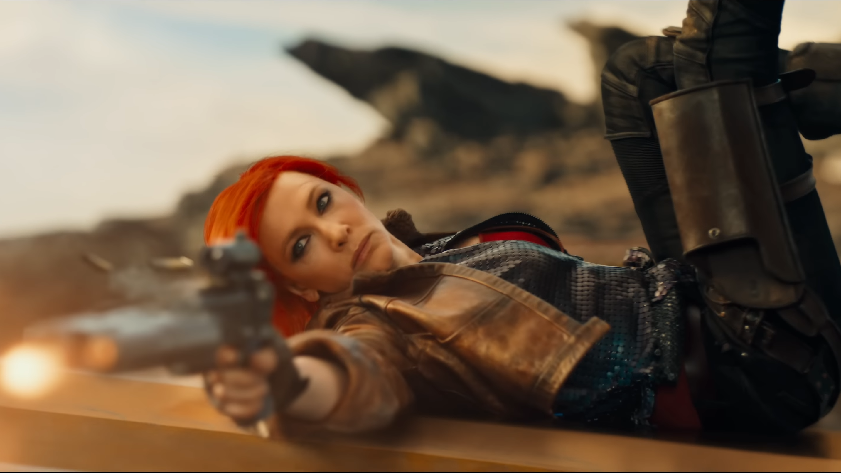 Cate Blanchett rolls over an obstacle as she fires her pistol in Borderlands.