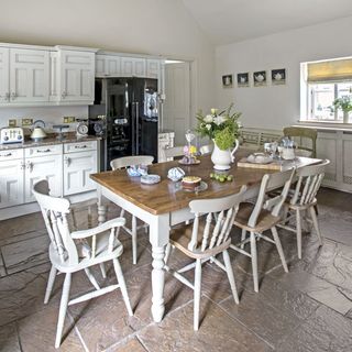 kitchen room with kitchen cabinets and table with chairs