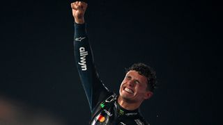 Reigning F1 champion Lando Norris of McLaren celebrates on the podium at Yas Marina Circuit in Abu Dhabi, United Arab Emirates