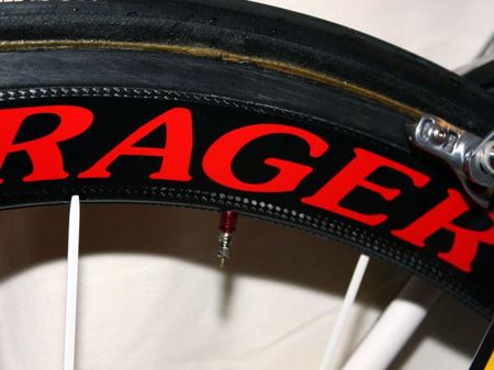 Red anodized aluminum valve extenders peek out from behind the carbon rim fairings.