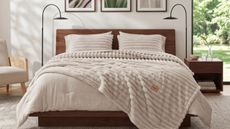 Bedsure 2-in-1 comforter on a double bed with dark wood bed, in a white bedroom with two matching black lamps and large window