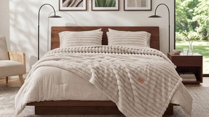 Bedsure 2-in-1 comforter on a double bed with dark wood bed, in a white bedroom with two matching black lamps and large window