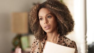 Kerry Washington in UnPrisioned holding papers in beige polka dot blouse