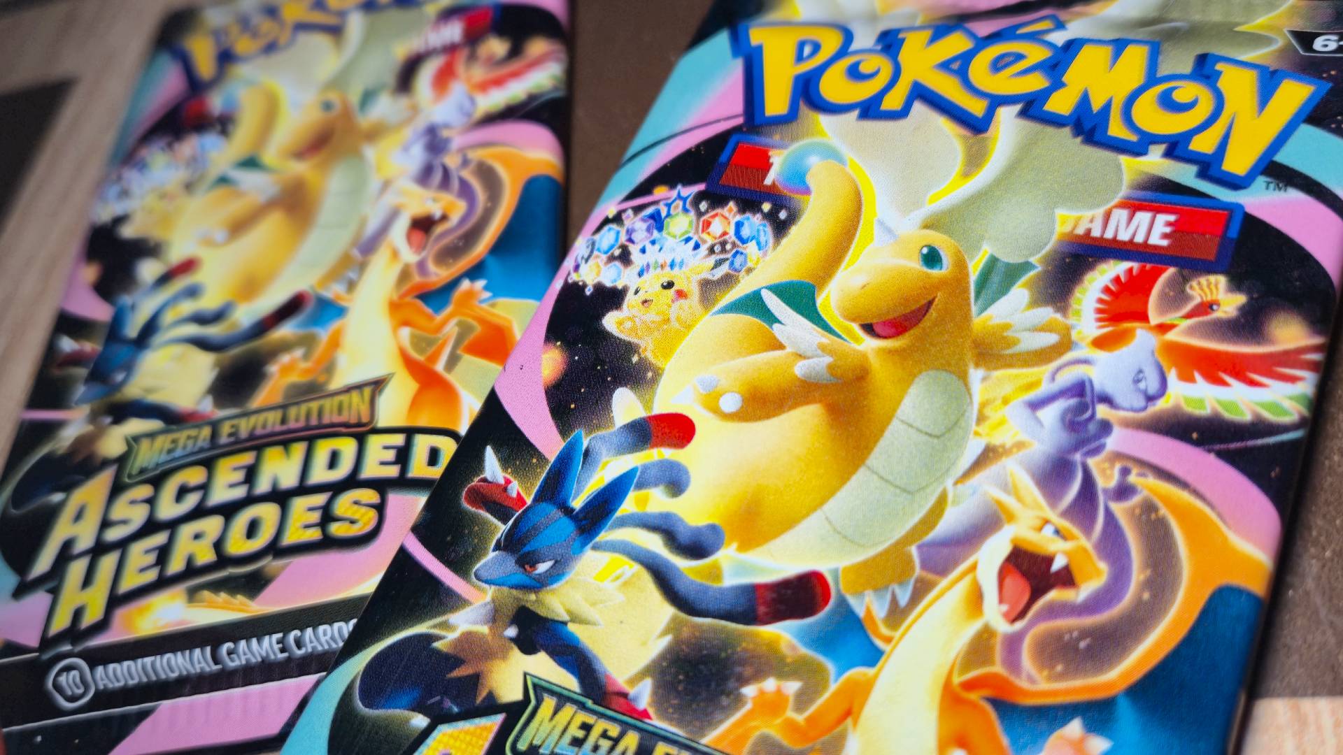 Close up of two Pokemon TCG Ascended Heroes booster packs.
