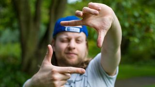 Man using hands to frame the scene in front of him