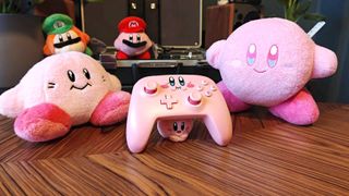PowerA Kirby controller for Nintendo Switch surrounded by Kirby toys