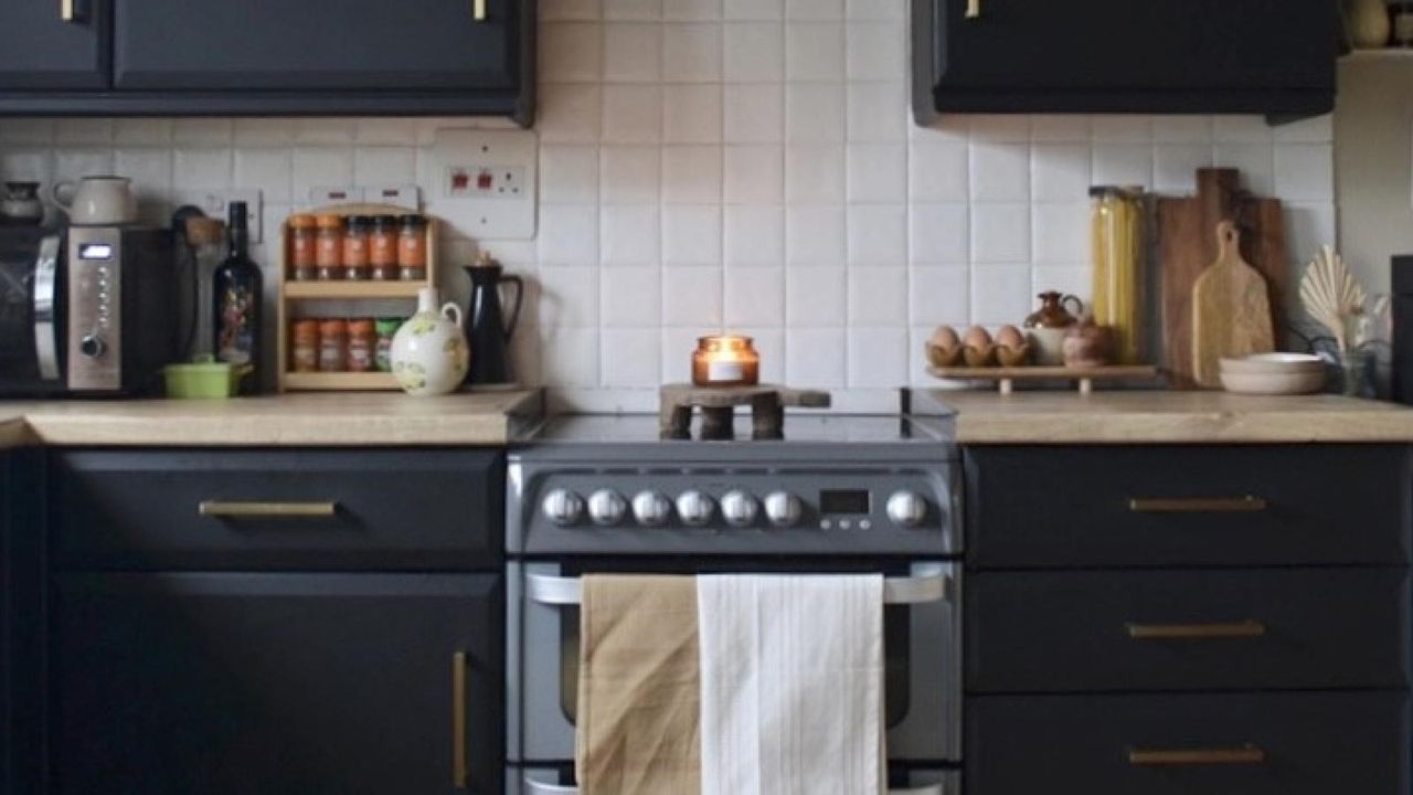 dark kitchen cabinets with oven and tea towel