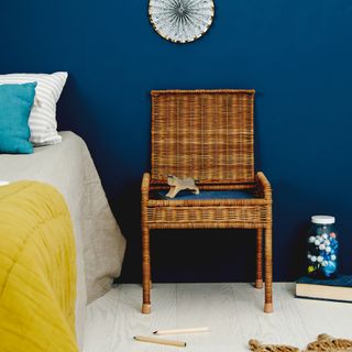bedroom with blue wall toy and book wooden chair