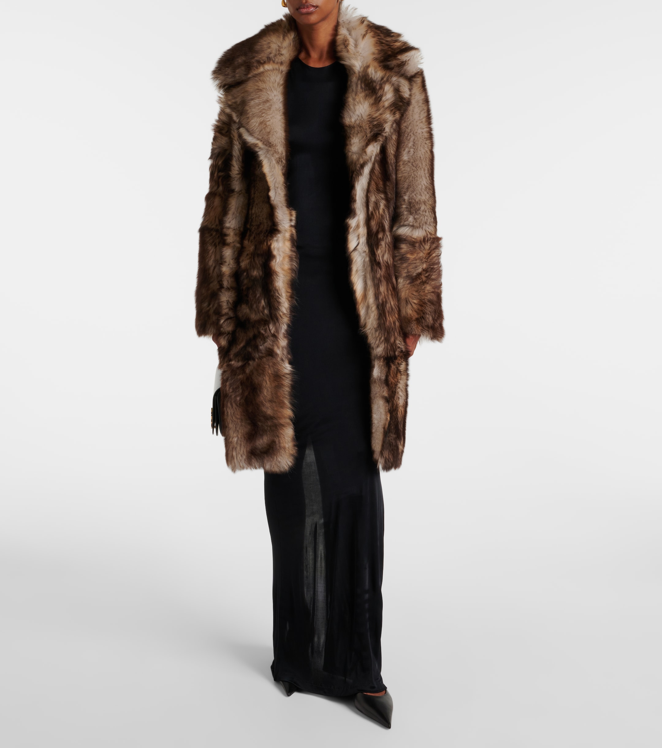 a model wearing a nour hammour shearling coat