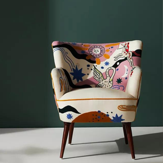 A chair with celestial patterns against a green background