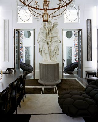 A large marble statue with two doors leading from a dining to a living room at Karl Lagerfeld's Paris apartment