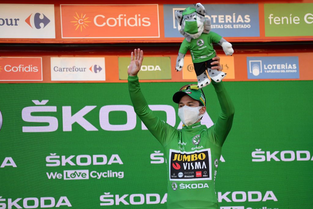 AGUILAR DE CAMPOO SPAIN OCTOBER 29 Podium Primoz Roglic of Slovenia and Team Jumbo Visma Green Points Jersey Celebration Mascot during the 75th Tour of Spain 2020 Stage 9 a 1577km stage from Cid Campeador Military Base Castrillo del Val to Aguilar de Campoo lavuelta LaVuelta20 on October 29 2020 in Aguilar de Campoo Spain Photo by David RamosGetty Images
