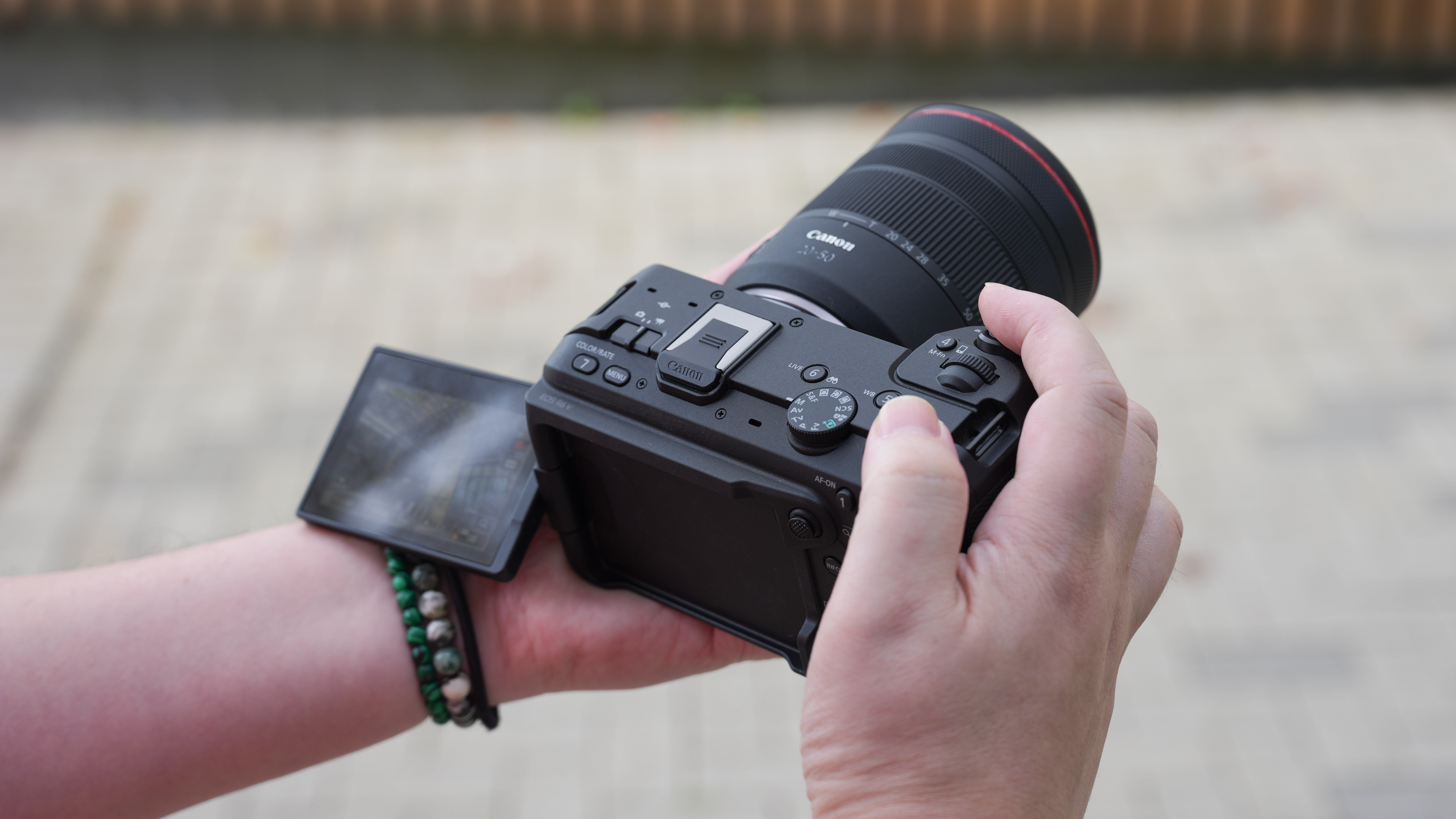 Canon EOS R6 V with the Canon RF 20-50mm f/4L IS USM PZ being held outdoors