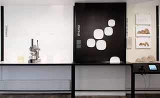 A milk lab split into 3 sections - Hyperbol, Ephemilk and Cloches Affines. The display is on a black and white shelf with the equipments placed on it