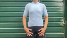 DHB Aeron Ultra Womens Short Sleeve Jersey in blue on a white woman standing in front of a green garage door