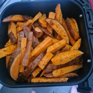 Instant Vortex Mini Air Fryer with open drawer containing spiced unpeeled sweet potato chips