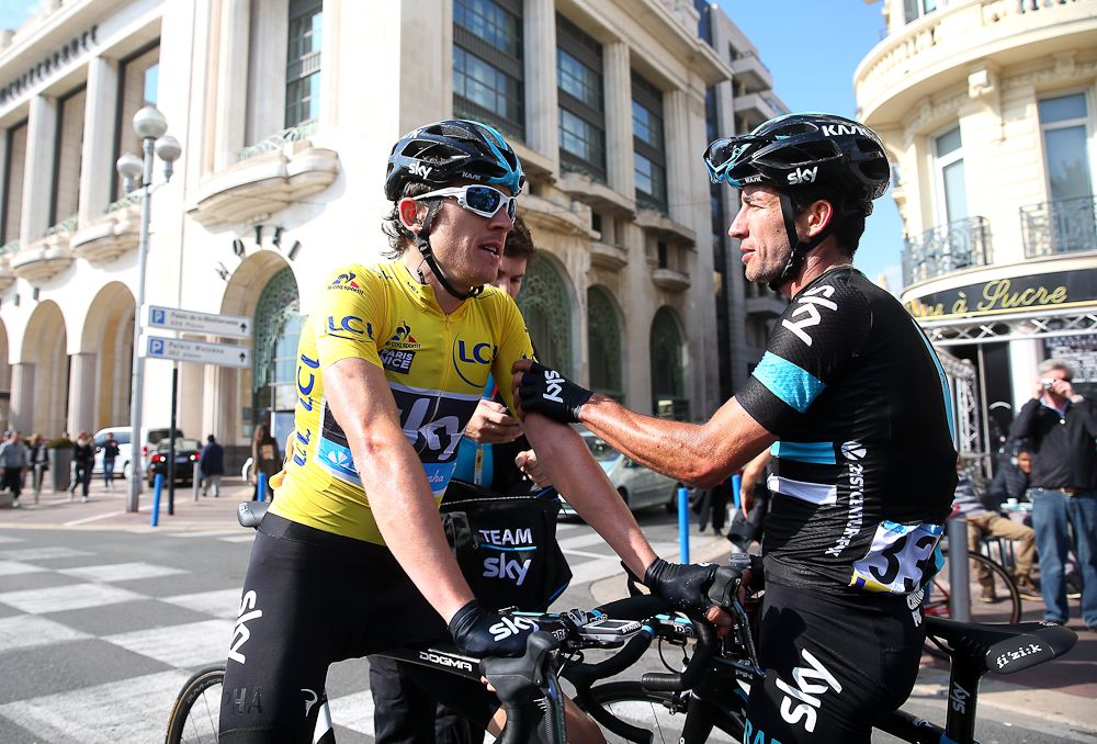 Race winner Geraint Thomas of Great Britain and Team Sky is congratulated by teammate Sergio Luis Henao of Colombia