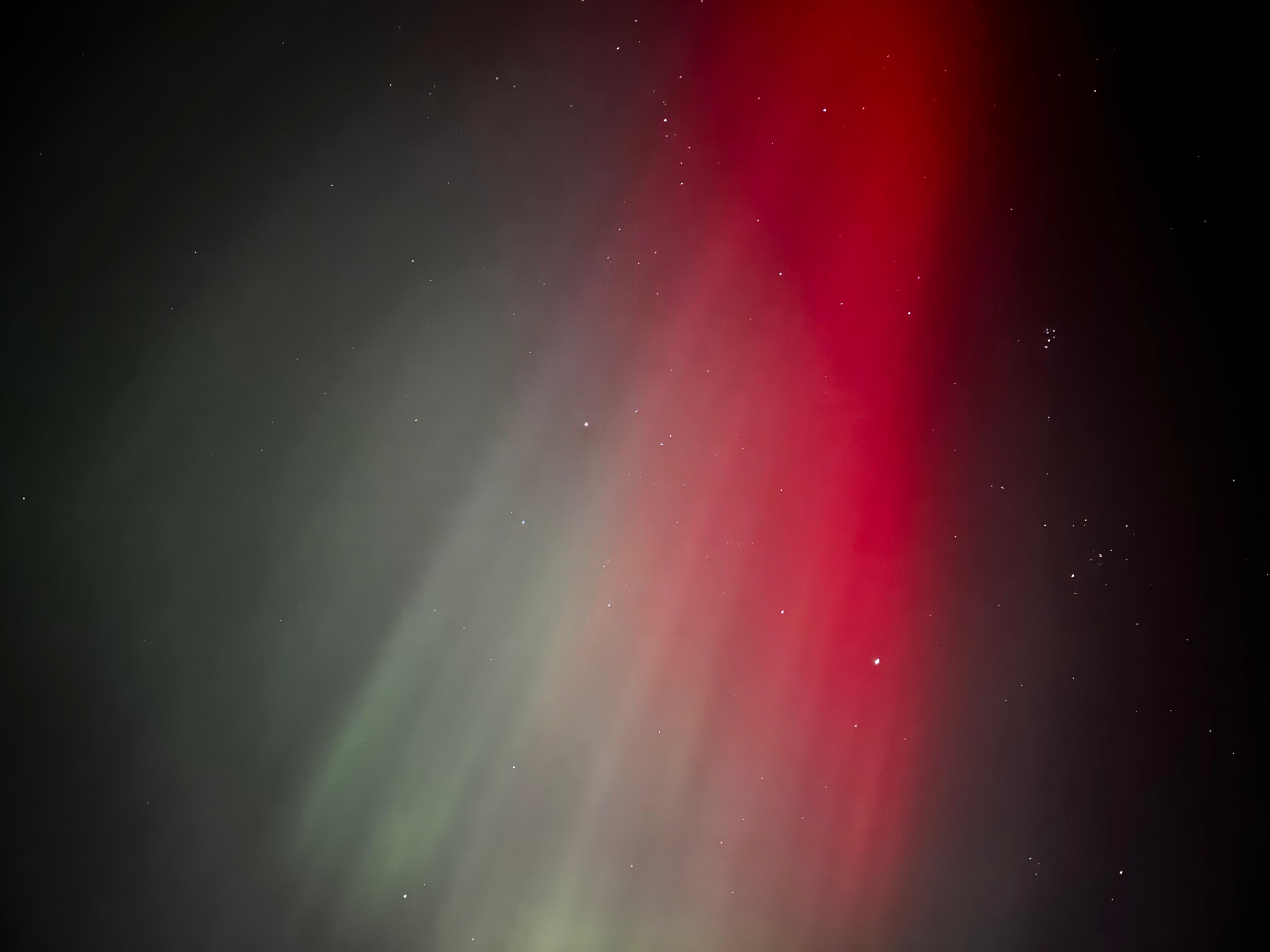 The Northern Lights' red and green pillars decorating the night sky