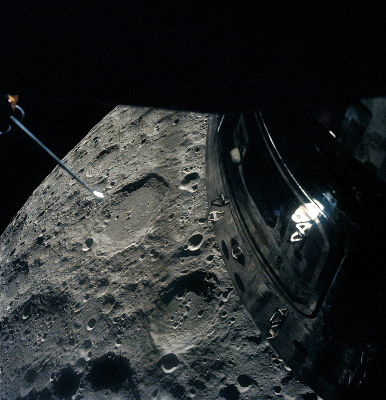 The moon and command module of Apollo 13 as seen from the mission's lunar module on April 15, 1970, a day after the crew and spacecraft set a record for the farthest distance traveled from Earth