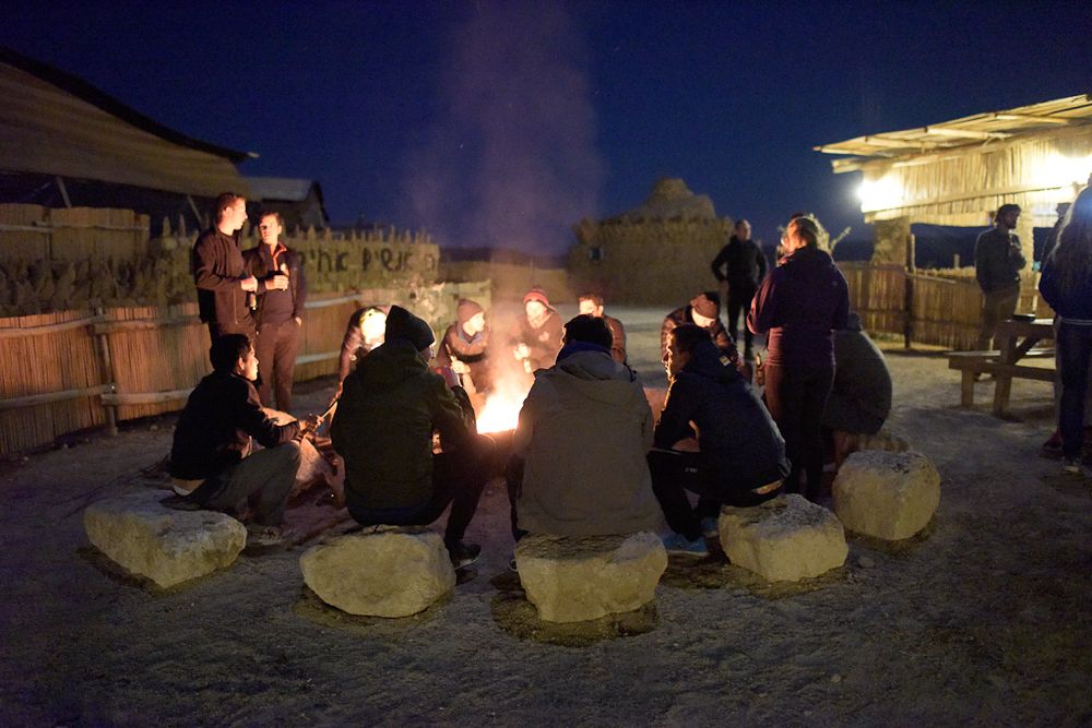 Riders enjoy a fireside evening in a Bedouin village.