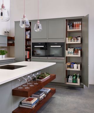 Kitchen island with floating shelves, styled with wine glasses, books and succulents