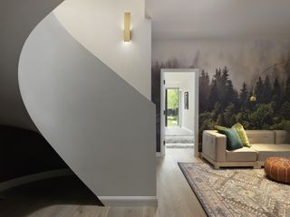 living space with mural and twisted staircase at Wraparound House by SAW