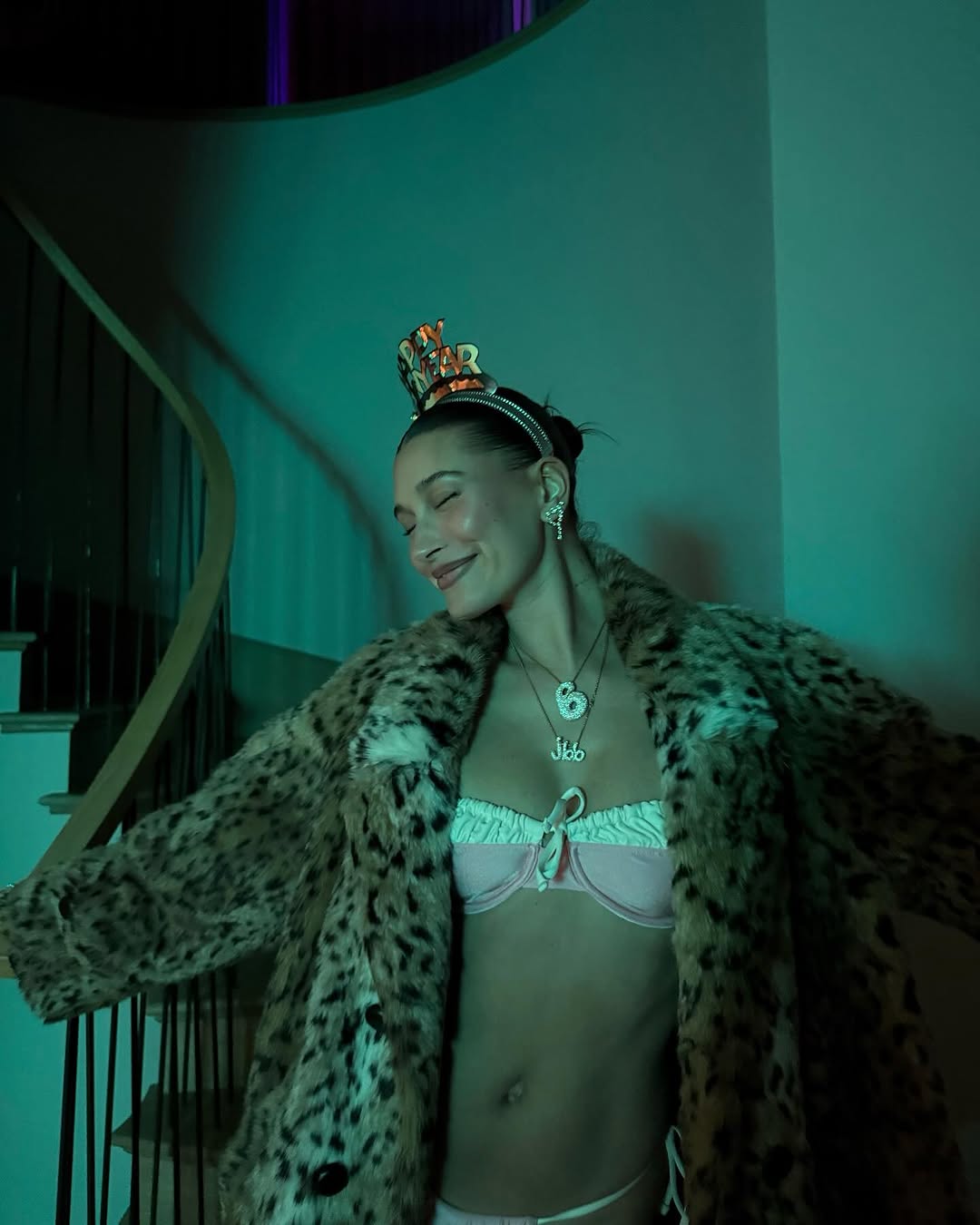 Hailey Bieber wearing bikini and leopard coat on New Year's Eve.