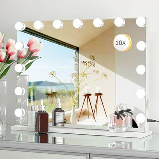 Hollywood style vanity mirror mounted on white wall
