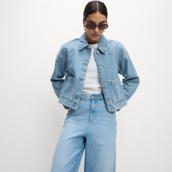 A model wears a cropped denim shacket and jeans
