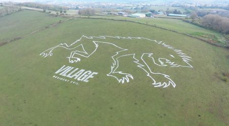 The white outline of a stylised Lycan dominates this Somerset hillside