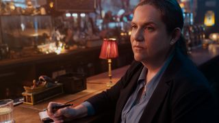 Detective Nikki Henry sits at a bar in The Perfect Couple